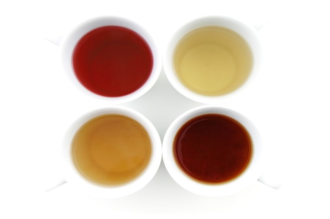 Different flavor of drinks in four white cups