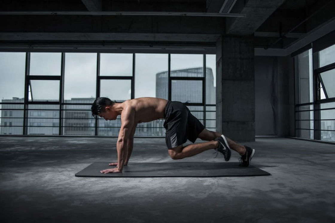 Man working out in a black mat