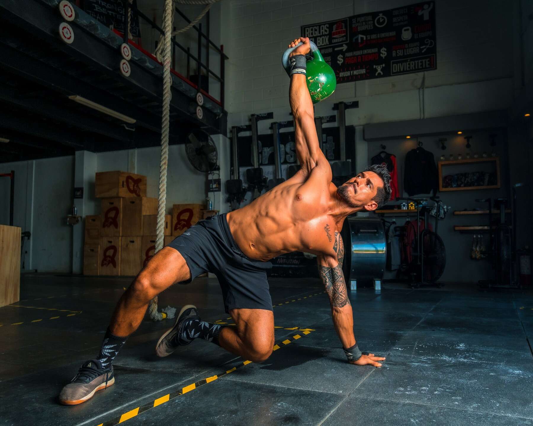 Muscular and toned man working out with dumbbell