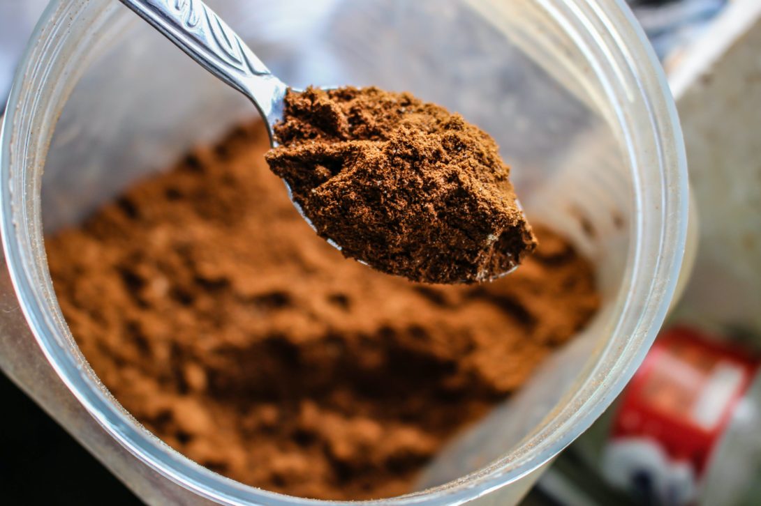 A chocolate protein powder in a spoon