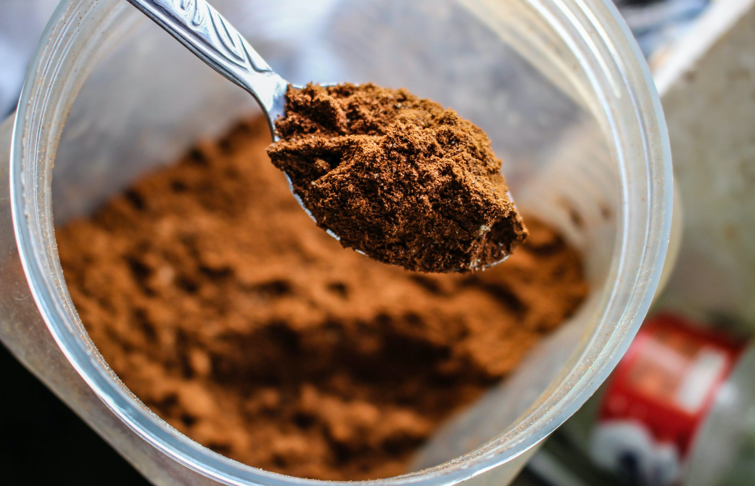 A chocolate protein powder in a spoon