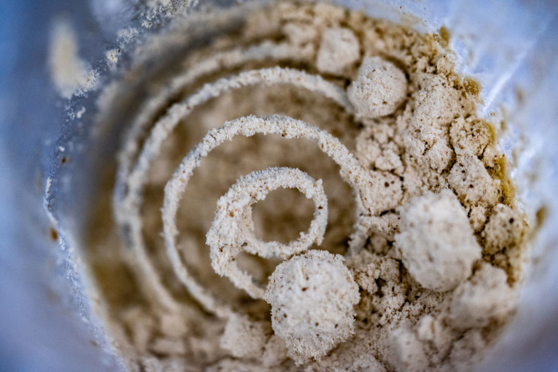 Protein powder being mixed inside a blender