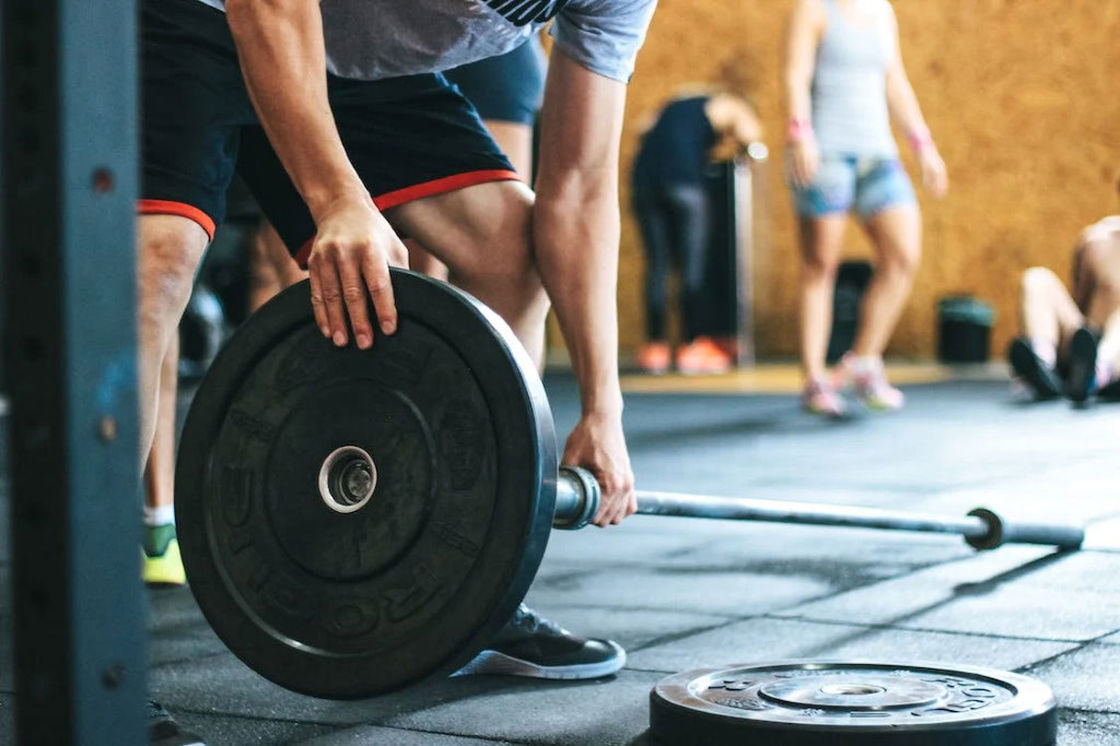 Man fixing the weights in his barbell