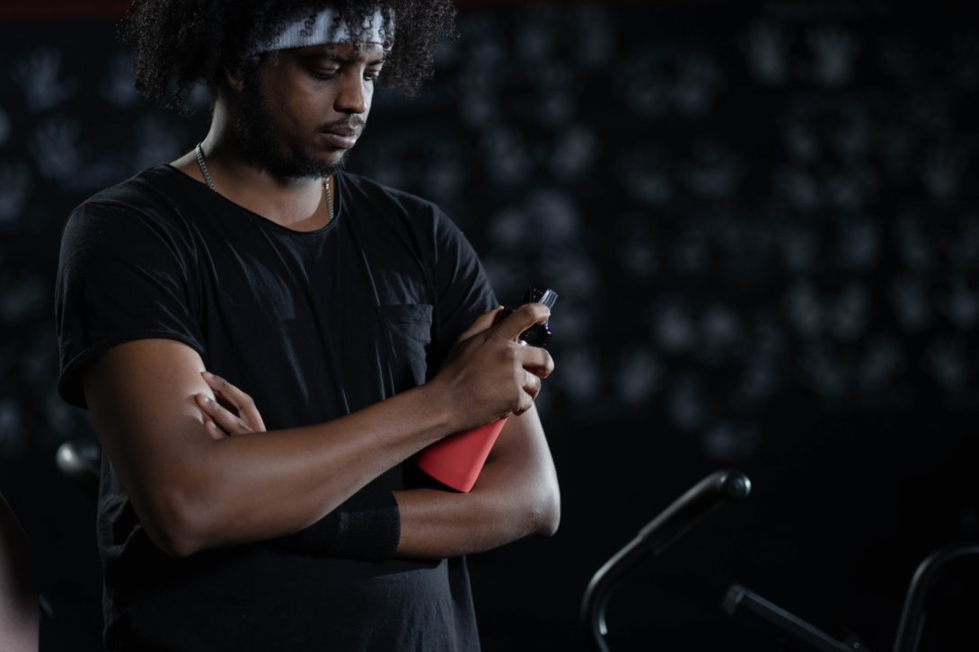 Man at the gym holding a stainless steel water bottle