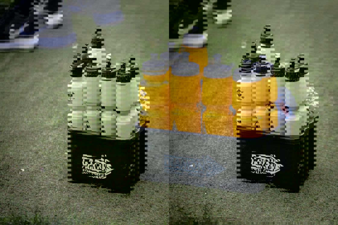Box of sports drinks on a grass field