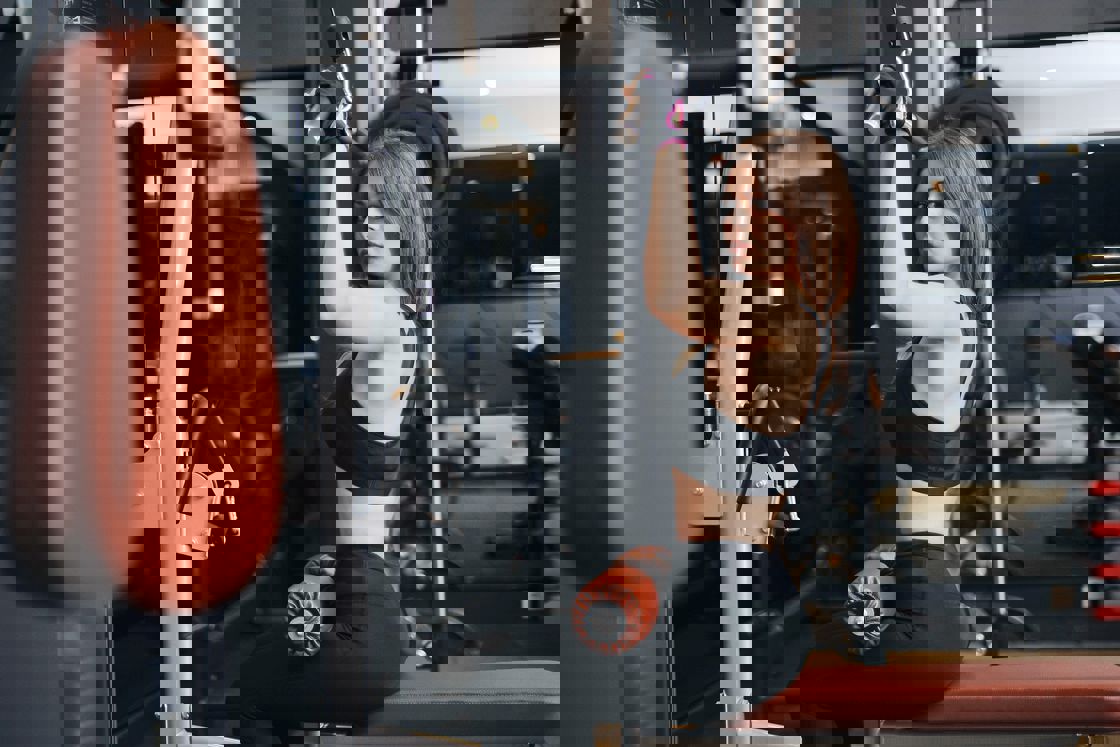Woman using a pull down machine at the gym