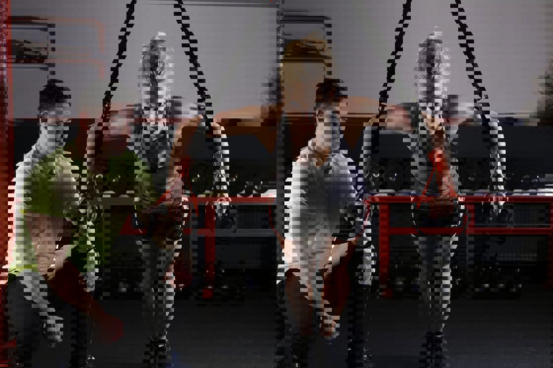 Trainer guiding a woman as she works out