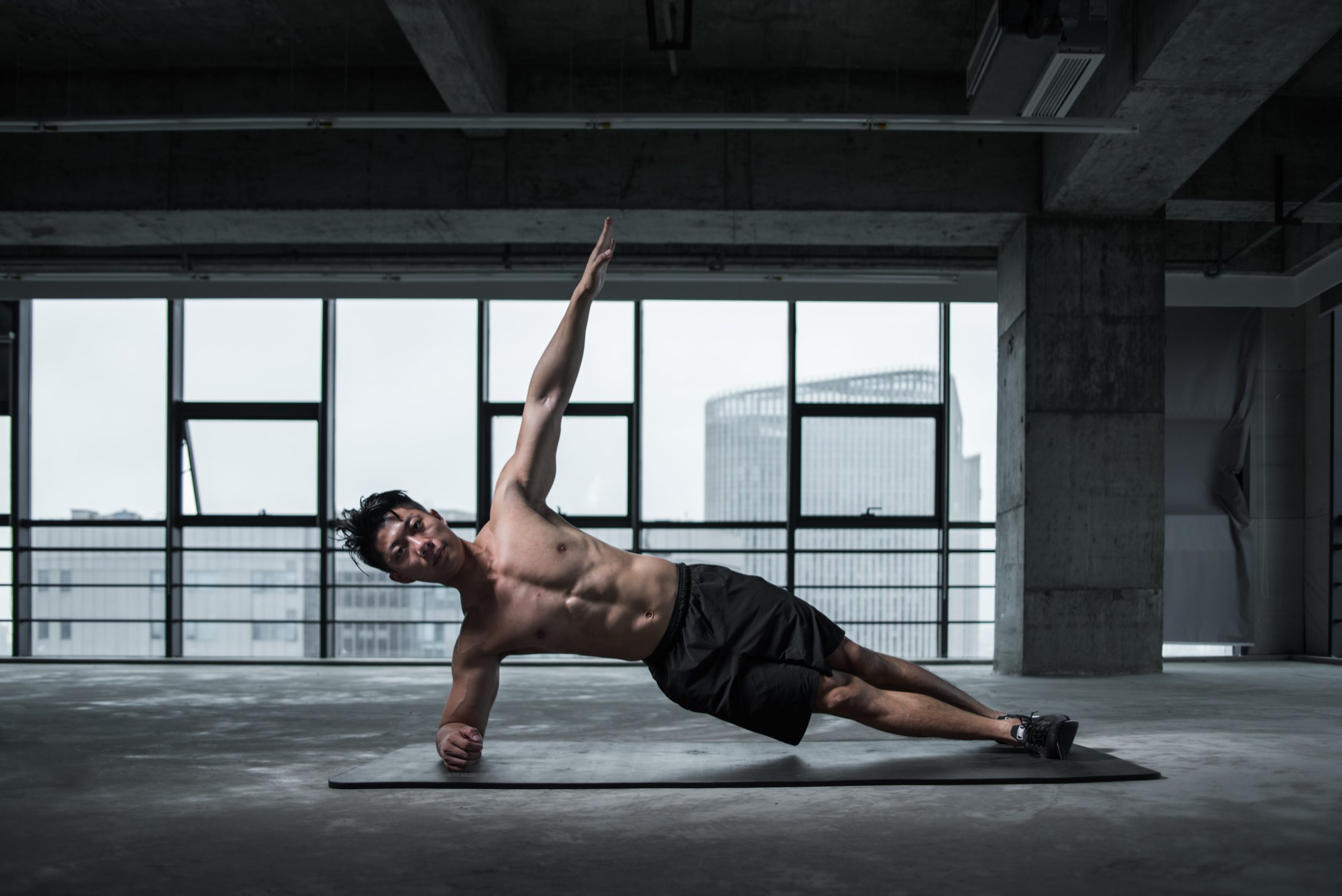 A man doing side exercise on a mat