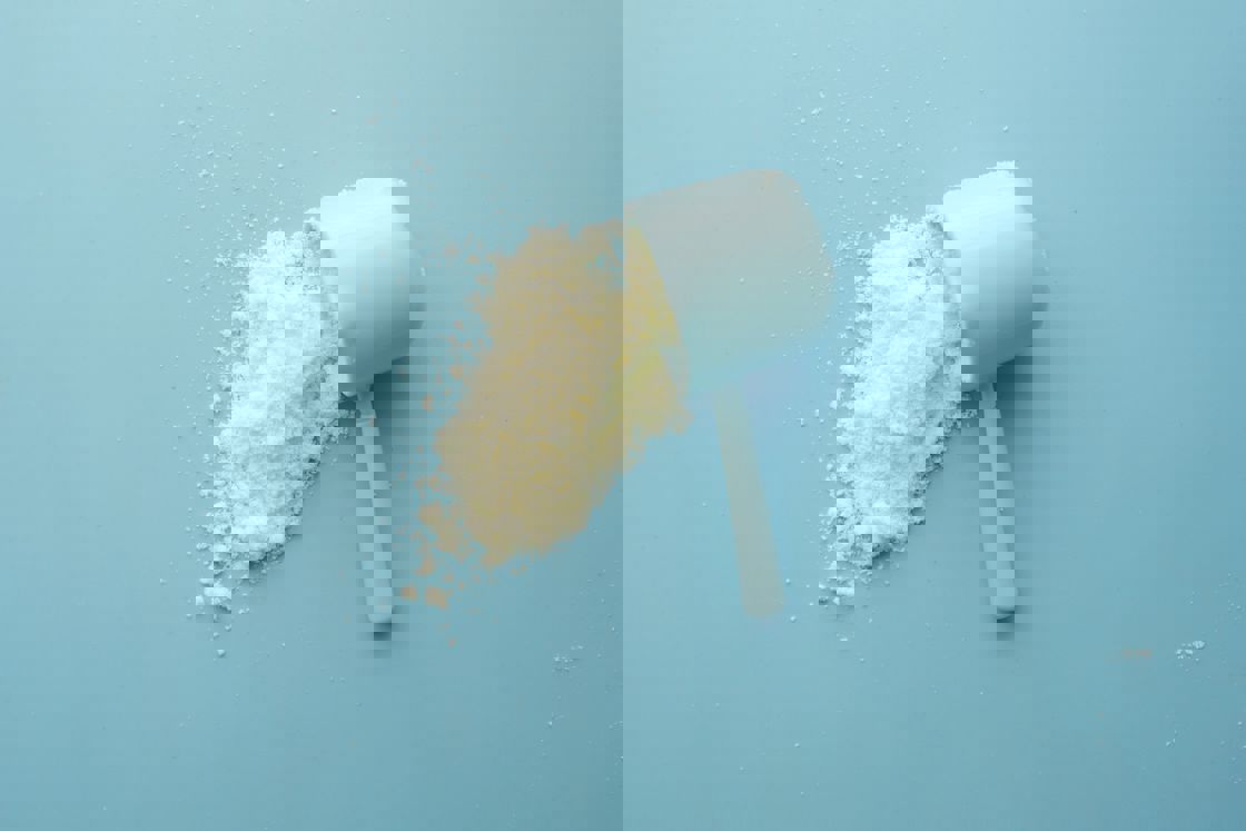 White powder spilling from a blue scooper