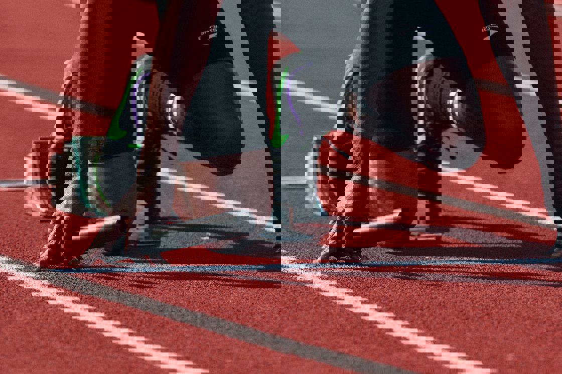 Man preparing to sprint at an outdoor track