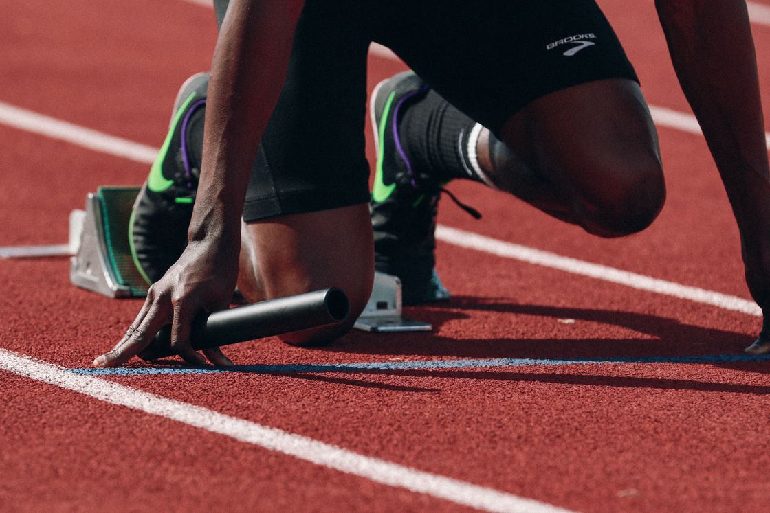 Man preparing to sprint at an outdoor track